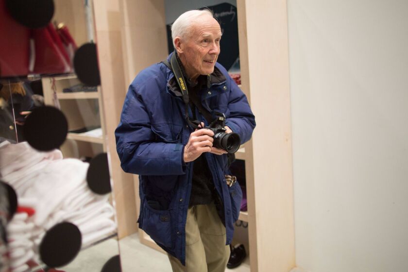 Mandatory Credit: Photo by Aflo/REX/Shutterstock (5738011a) Bill Cunningham Bill Cunningham, Manhattan, New York, USA - 21 Dec 2013 Fashion photographer Bill Cunningham takes a photo at a newly opened fashion retail and concept store during a preview in Manhattan, New York.