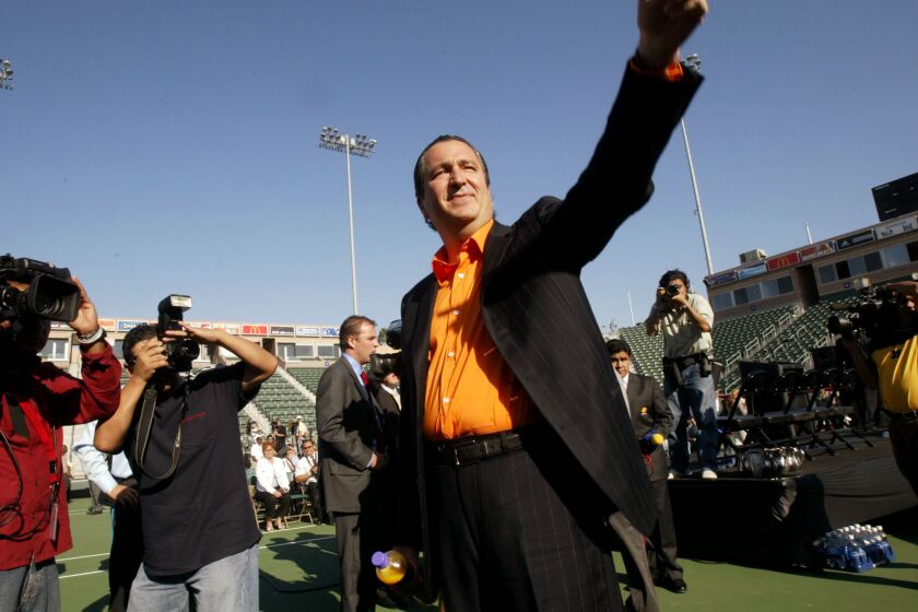 FILE - In this Aug. 2, 2004 file photo, Mexico's soccer club Deportivo Guadalajara "Chivas" owner Jorge Vergara waves to Mexican-American fans at the start of a news conference in Carson, Calif. Vergara, the longtime owner of Chivas team, has died at age 64 in New York City on Friday Nov. 15, 2019. (AP Photo/Ric Francis, File )