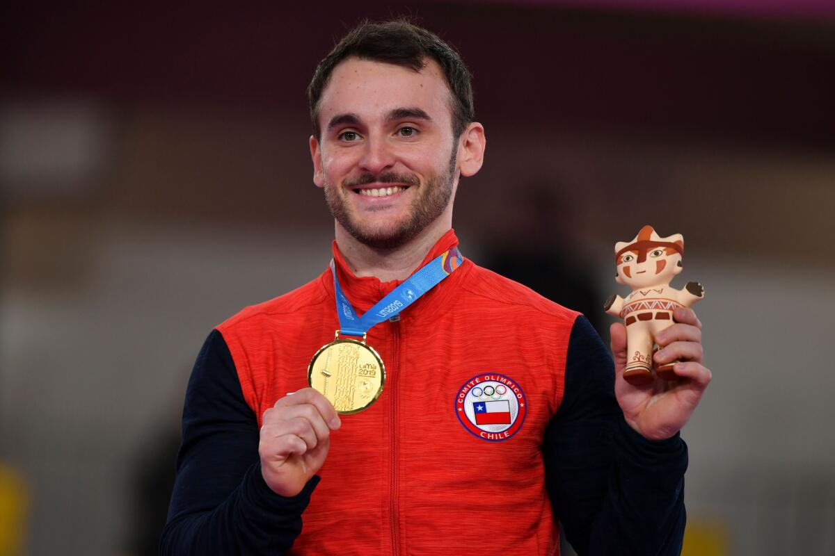 Chile's Enrique Tomas Gonzalez poses on the podium with the gold medal after winning the Artistic Gymnastics Men's Floor Exercise Final during the Lima 2019 Pan-American Games in Lima, on July 30, 2019. (Photo by Luis ACOSTA / AFP)LUIS ACOSTA/AFP/Getty Images ** OUTS - ELSENT, FPG, CM - OUTS * NM, PH, VA if sourced by CT, LA or MoD **