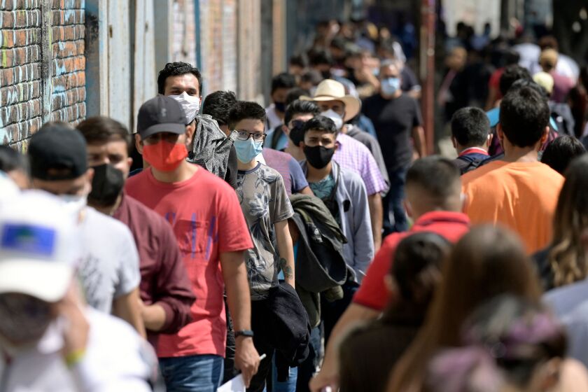 People aged 18 to 29 years old line up outside the "Biblioteca Vasconcelos" to receive their first dose of AstraZeneca vaccine against COVID-19 in Mexico City, on August 10, 2021, as Mexico faces a third wave of contagions. (Photo by ALFREDO ESTRELLA / AFP) (Photo by ALFREDO ESTRELLA/AFP via Getty Images)