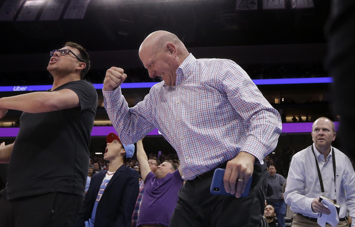 Los Angeles Clippers owner Steve Ballmer, center, celebrates in the closing moments of the Clippers 116-109 win over the Sacramento Kings in an NBA basketball game in Sacramento, Calif., Friday, March 1, 2019. (AP Photo/Rich Pedroncelli)