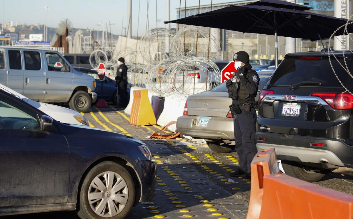 U.S. Customs and Border Protection agents inspect U.S.-bound travelers at the "limit line"