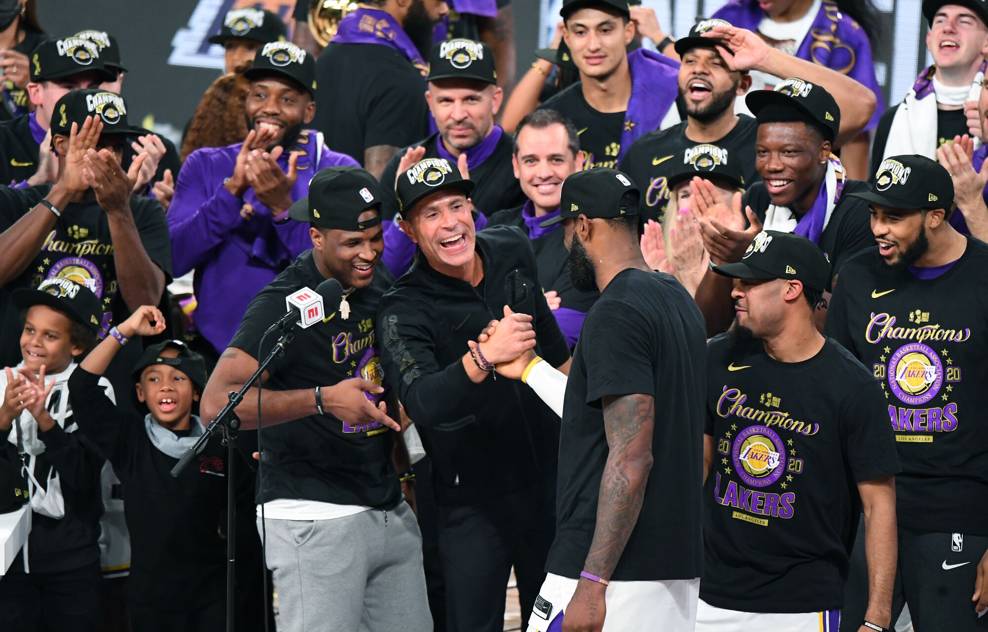 LeBron James and Rob Pelinka clasp hands after the Lakers' championship win.