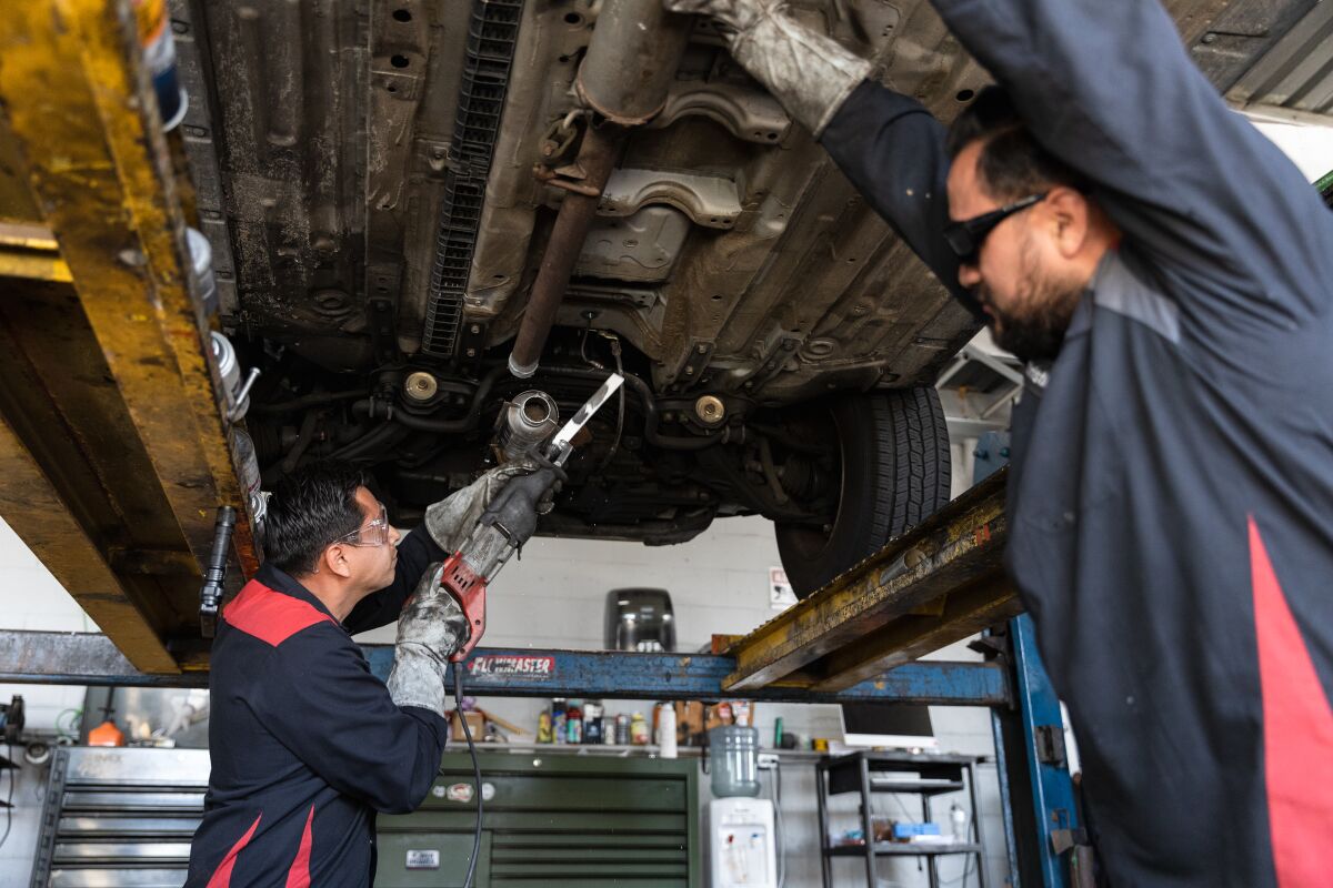 Jorge Medina, owner of Barrio Auto Service, demonstrates how a catalytic converter is quickly cut off. 