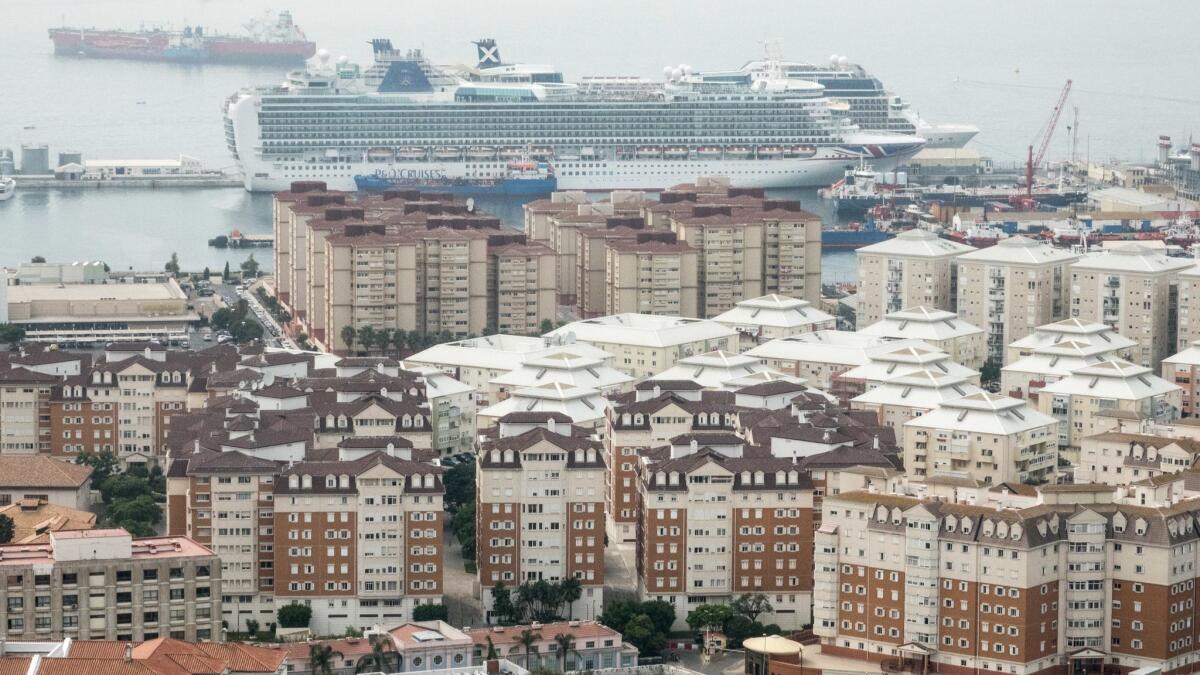 Blocks of apartment houses crowd a neighborhood near a cruise ship dock in Gibraltar.
