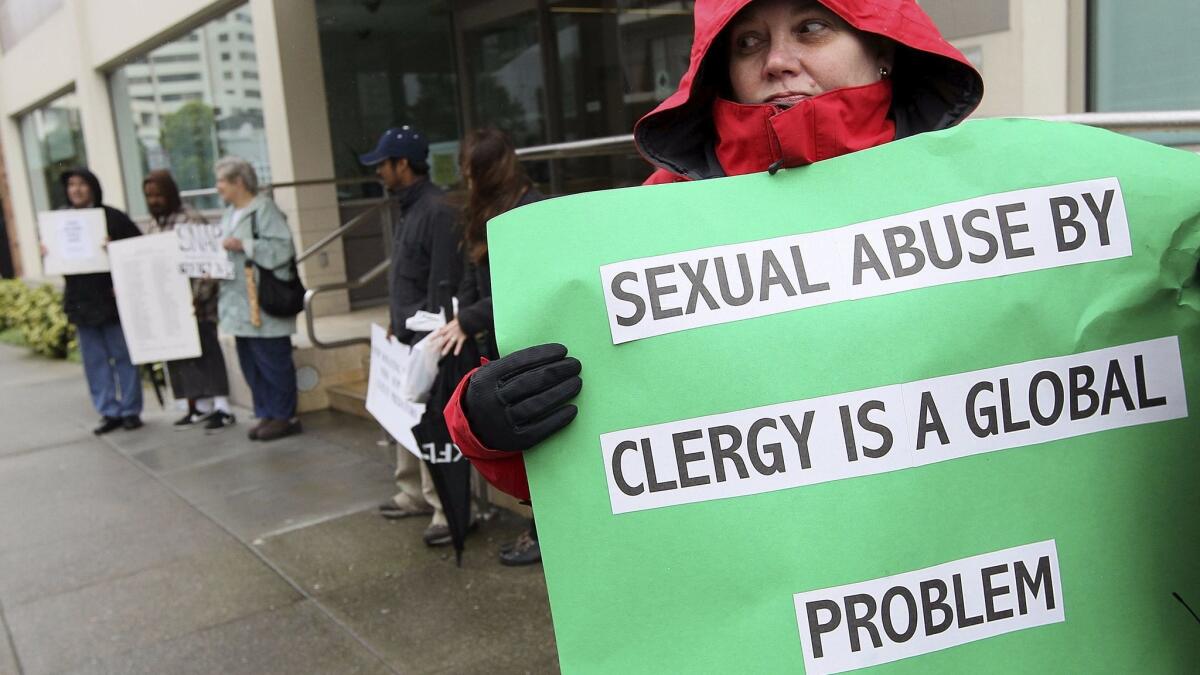 Melanie Sakoda holds a sign as she participates in a demonstration with SNAP, the Survivors Network of those Abused by Priests, outside of the offices of the San Francisco Archdiocese in 2010.
