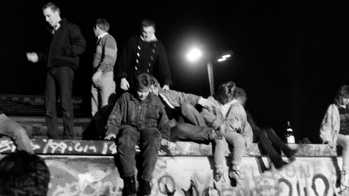 West Berliners climb on the Berlin Wall on Nov. 10, 1989.