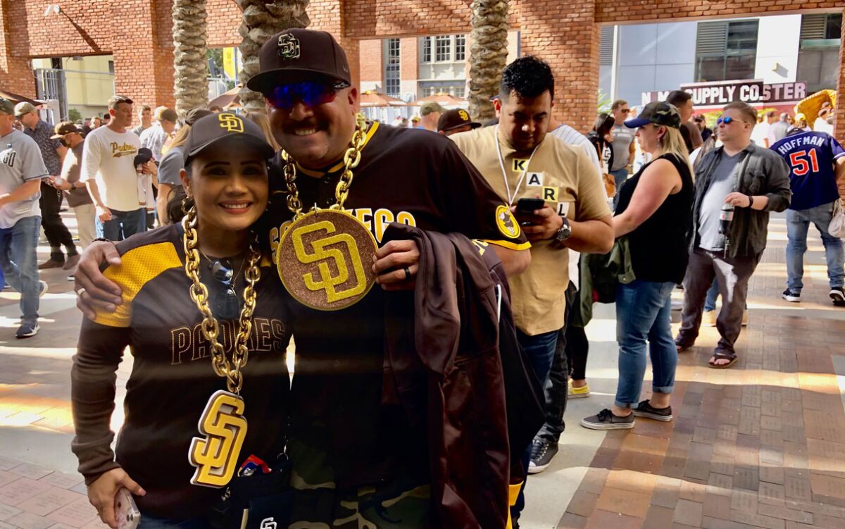 Sylvia and Sergio Romero of El Centro wait in line to buy gear at the Padres Team Store before Thursday's home opener.
