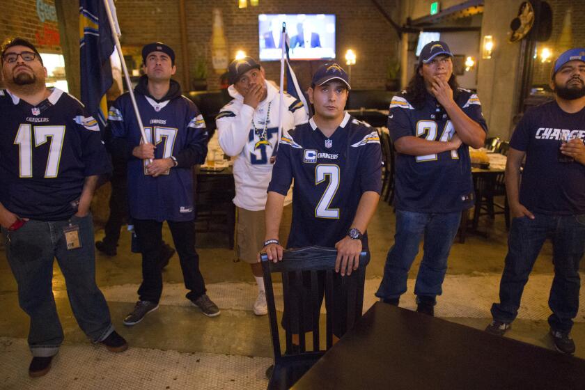 Los Angeles fans of the San Diego Chargers react to news from the NFL owners meeting during a meet-up at El Compadre Restaurant on Jan. 12.