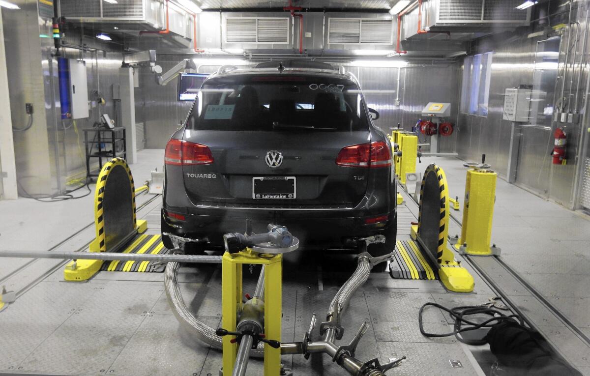 Volkswagen denied installing software in six-cylinder diesel vehicles that changes engine performance during emissions testing. Above, a VW Touareg diesel is tested last month at an EPA facility in Michigan.