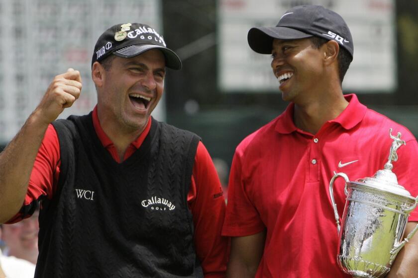 FILE - In this June 16, 2008, file photo, Rocco Mediate. left, jokes with Tiger Woods following Woods' U.S. Open championship victory after playing a sudden death hole following an 18-hole playoff round for the US Open championship at Torrey Pines Golf Course in San Diego. The U.S. Open is switching this year to a two-hole aggregate playoff. (AP Photo/Chris Carlson, File)