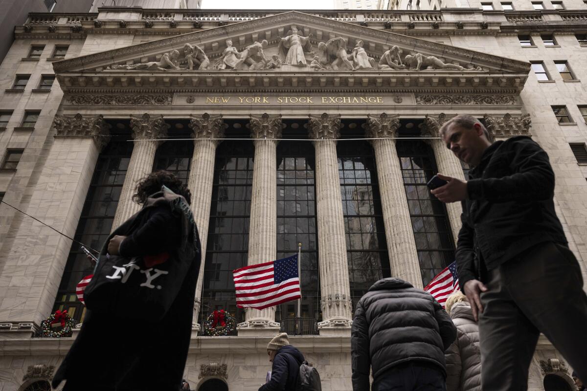 People walk past the New York Stock Exchange 