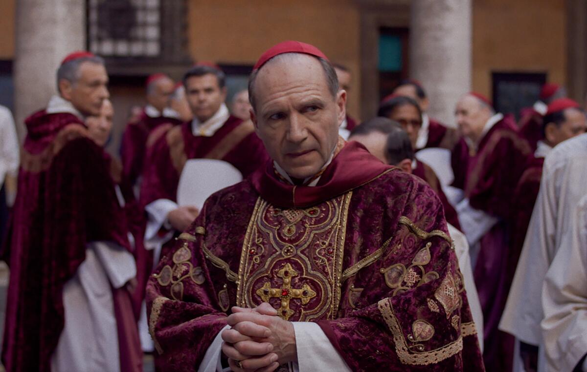 A cardinal in red considers important papal matters.