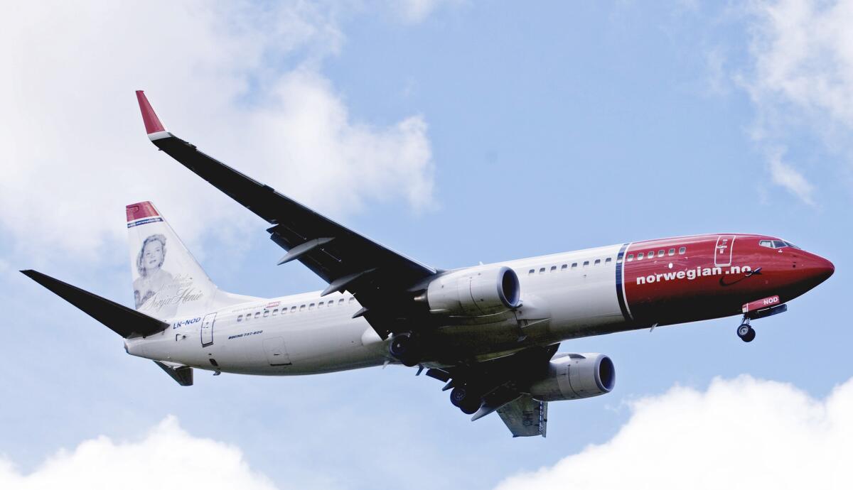 Boeing 737-800 of low-cost airline Norwegian flying near Oslo airport in Gardermoen.