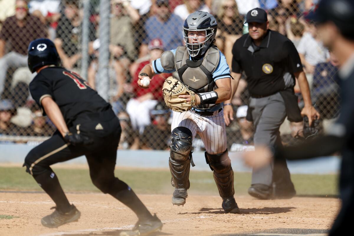 JSerra baserunner Jackson Summers is caught in a rundown by Villa Park catcher Jack Burke.