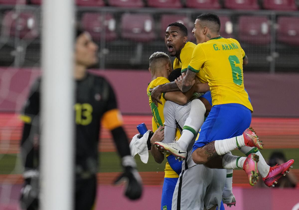 Brazil's players celebrate after defeating Mexico in a penalty shootout in the Olympic semifinals Tuesday.