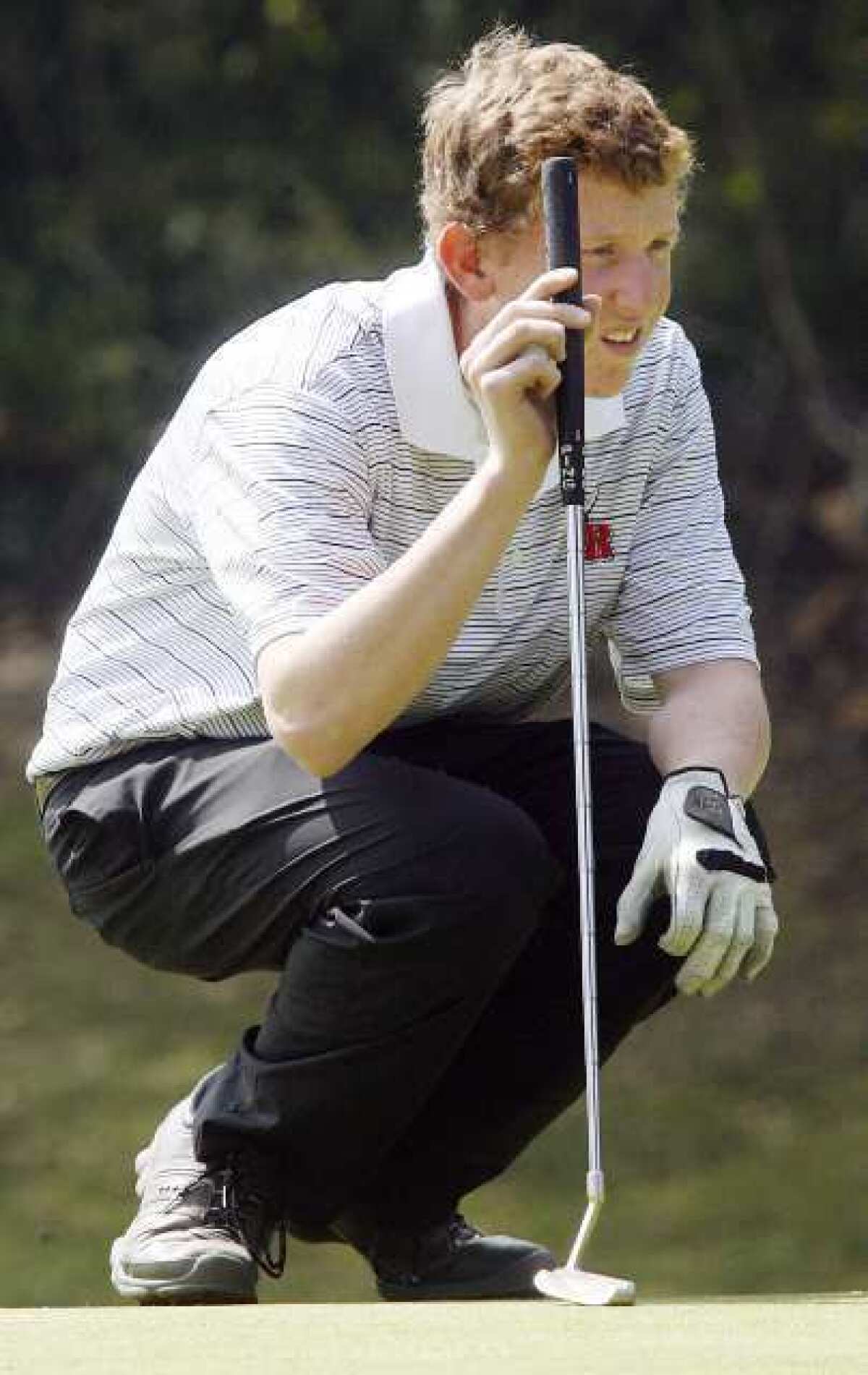 ARCHIVE PHOTO: Burroughs' Sean White lines up a putt on the fifth green in a Pacific League boys golf match against Crescenta Valley, Pasadena, Burroughs, Burbank, and Arcadia at Brookside Golf Course in Pasadena on Thursday, March 15, 2012.