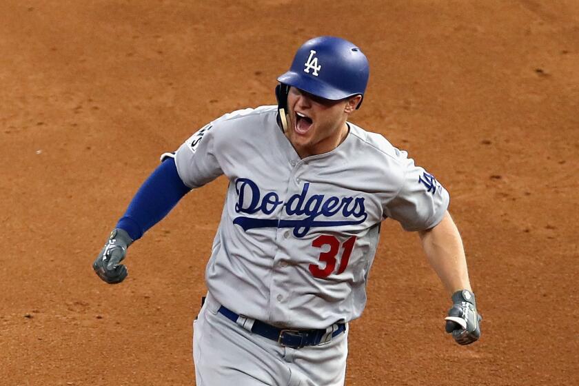 The Dodgers' Joc Pederson celebrates after hitting a three-run home run during the ninth inning against the Houston Astros in Game 4 of the World Series on Saturday night.