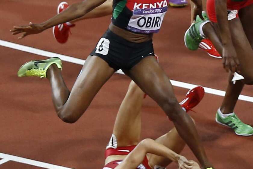 Kenya's Hellen Onsando Obiri leaps to avoid Morgan Uceny of the United States during the women's 1,500-meter final.