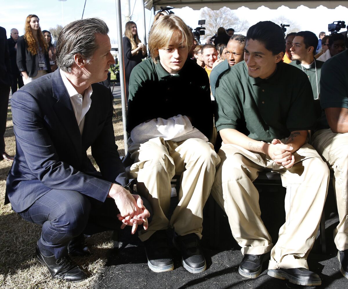 Governor Gavin Newsom talks with young men at a youth correctional facility 