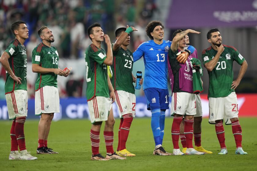 Mexico goalkeeper Memo Ochoa and teammates salute fans after a draw with Poland