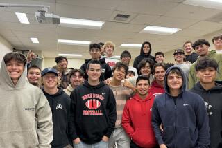 Burroughs coach Jesse Craven is surrounded by players from his Pacific League championship team on Saturday morning.