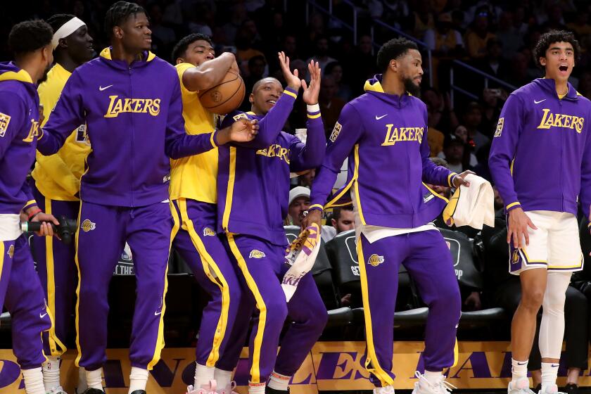 Los Angeles, CA - April 09: The Lakers bench cheers for the starters during the regular sesaon finale.