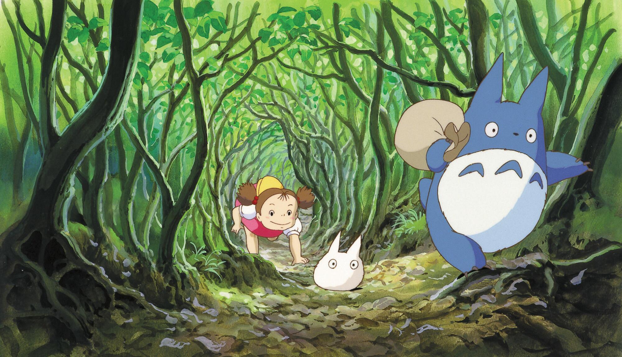 A girl chases two small creatures through a tunnel of trees in a scene from the animated "My Neighbor Totoro"