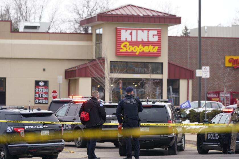 Police stand outside a King Soopers grocery store where a shooting took place, Monday, March 22, 2021, in Boulder, Colo. (AP Photo/David Zalubowski)