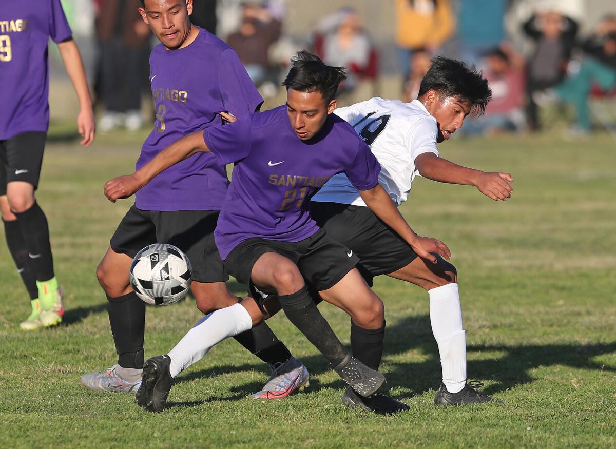 Los Amigos midfielder Allan Marquina (19) and Santiago's Bryan Palacios battle for control of the ball.