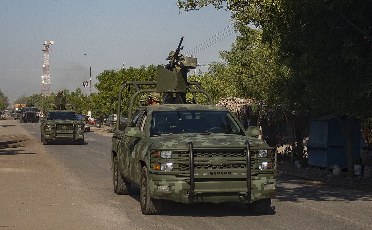 A convoy of vehicles from the Mexican Army patrol during the visit of Monsignor Franco Coppola in Aguililla, Mexico