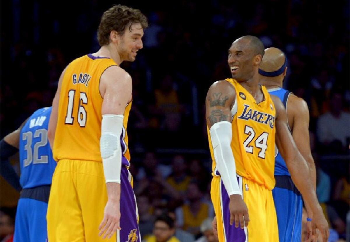 Pau Gasol and Kobe Bryant share a laugh after Bryant snagged a rebound to complete a triple-double against the Dallas Mavericks.