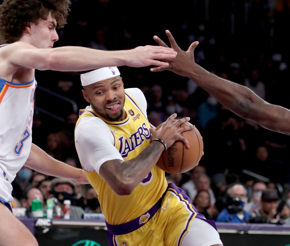 Lakers forward Kent Bazemore works to the basket against the Thunder.