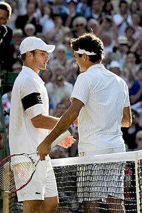 Switzerland's Roger Federer (R) shakes hands after winning against US Andy Roddick