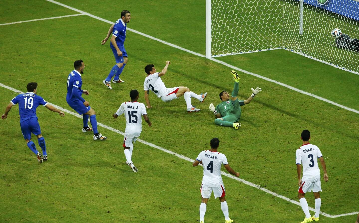 Greece's Papastathopoulos shoots to score against Costa Rica during their 2014 World Cup round of 16 game at the Pernambuco arena in Recife