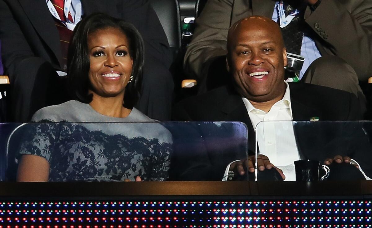 Craig Robinson sits next to his sister, First Lady Michelle Obama, at the 2012 Democratic National Convention.