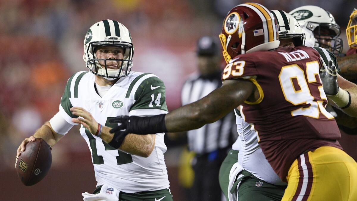 New York Jets quarterback Sam Darnold (14) looks to pass as Washington Redskins defensive end Jonathan Allen (93) is blocked during the first half.