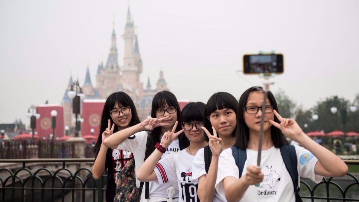 Visitors take a selfie after the opening ceremony of the Shanghai Disney Resort on June 16, 2016. A new digital version of Fastpass will launch in the fall.