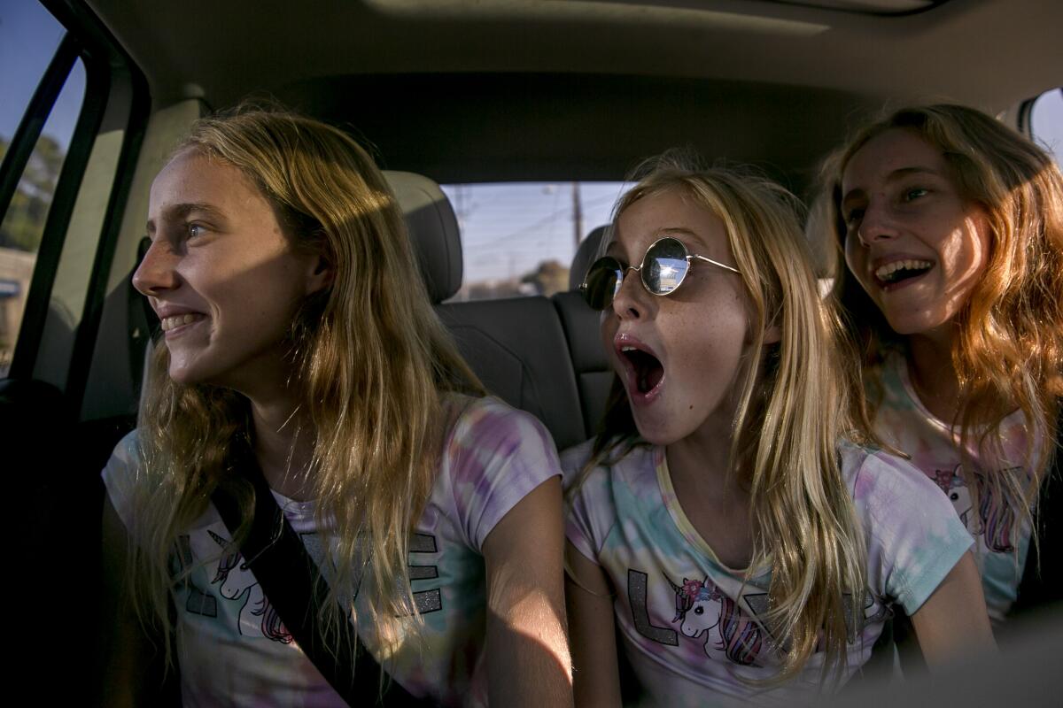 Brooklyn,  Bixby and Brinkley Baker get excited over something they see out the car window in Los Angeles. 