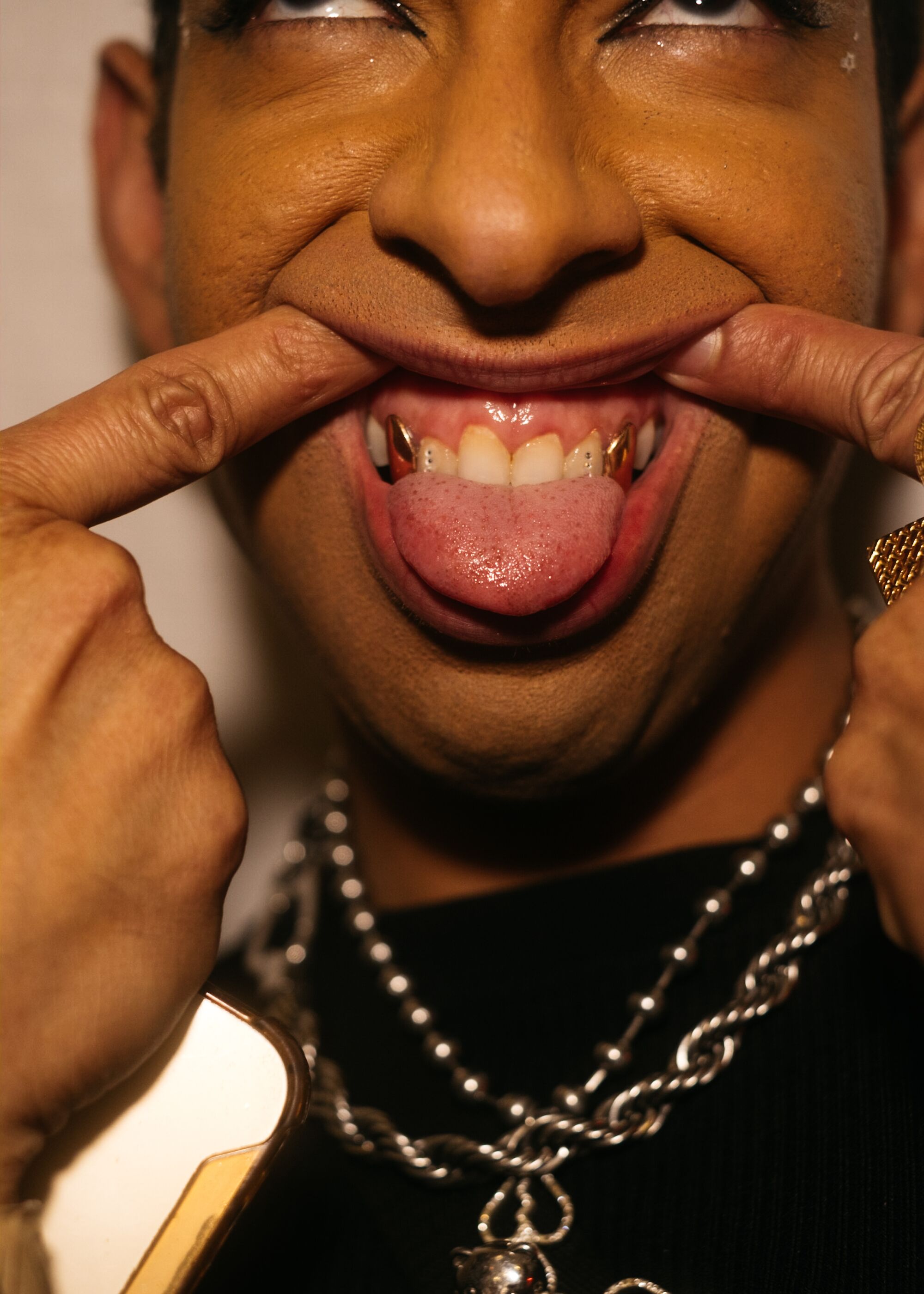 A Heav3n attendee shows off their bedazzled teeth.