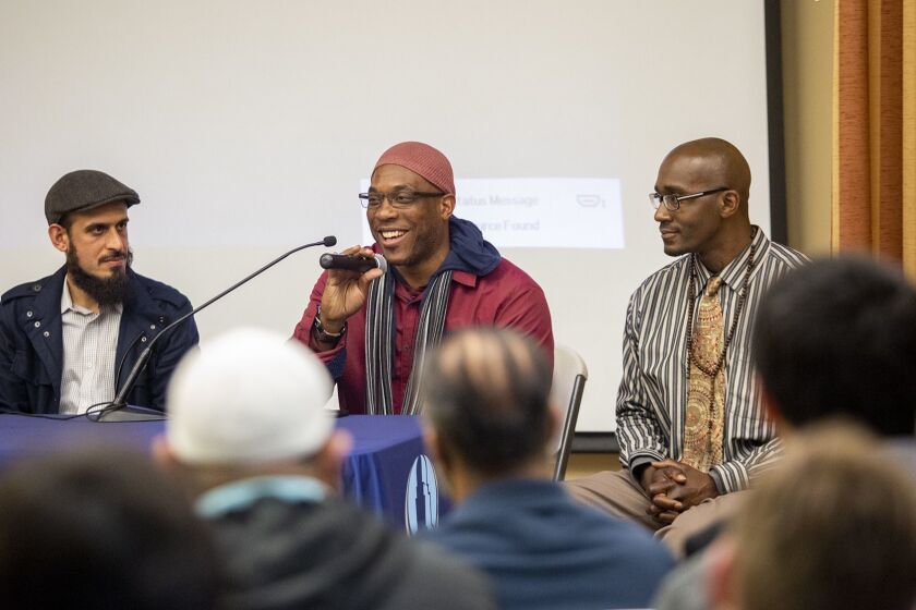 Amin Eshaiker, left, the program manager for Link Oustide, listens as Tobias Tubbs, 48, speaks about life in prison at the Islamic Institute of Orange County on Friday, February 15. Also in the photo is Gernay Quinnie Jr., 37.
