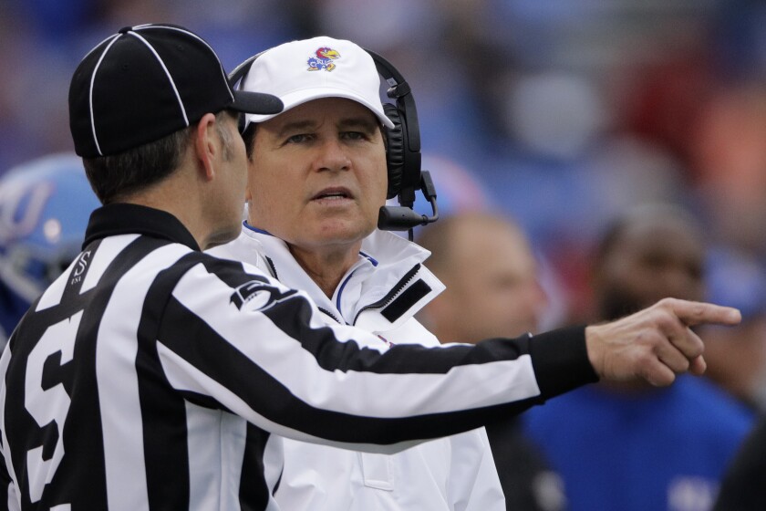 Kansas had coach Les Miles, talks to an official