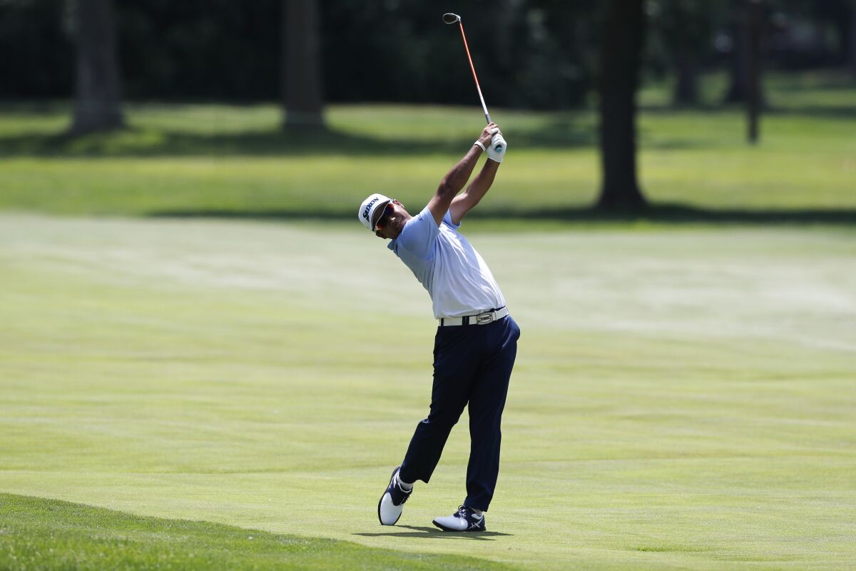 Hideki Matsuyama of Japan hits on the 17th fairway during the third round of the Rocket Mortgage Classic golf tournament, Saturday, July 4, 2020, at the Detroit Golf Club in Detroit. (AP Photo/Carlos Osorio)