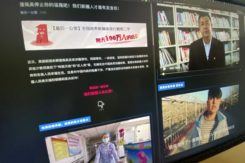 A webpage with the title "Pompeo stop your slanders! Only We Xinjiang people have a say!" and videos of ethnic Uyghurs responding to former U.S. Secretary of State Mike Pompeo is seen on a computer screen in Beijing on Wednesday, May 19, 2021. China has highlighted an unlikely series of videos this year in which Uyghur men and women deny U.S. charges that Beijing is committing human rights violations against their ethnic group. In fact, a text obtained by the AP shows that the videos are part of a government campaign that raises questions about the willingness of those filmed. (AP Photo/Ng Han Guan)