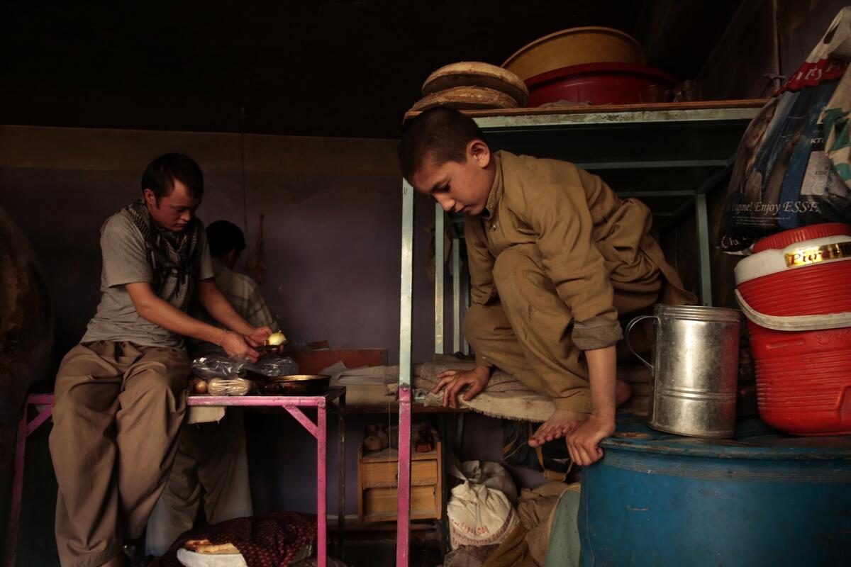 Sami's bed is on the platform where baking supplies are kept during the day. About 25% of children in Afghanistan work.