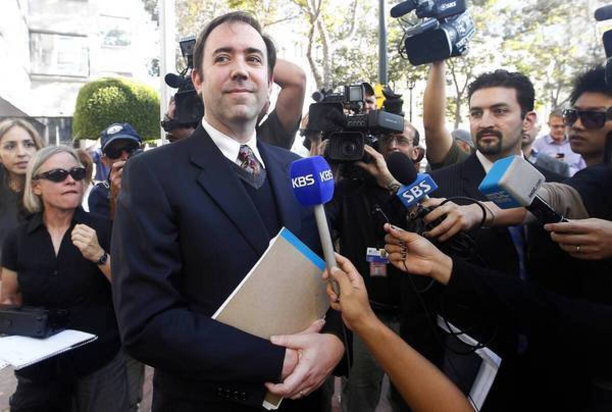 Jason Bartlett, center, an attorney for Apple, leaves the courthouse after the jury reached its decision. Apple said evidence in the trial “showed that Samsung’s copying went far deeper than even we knew.”