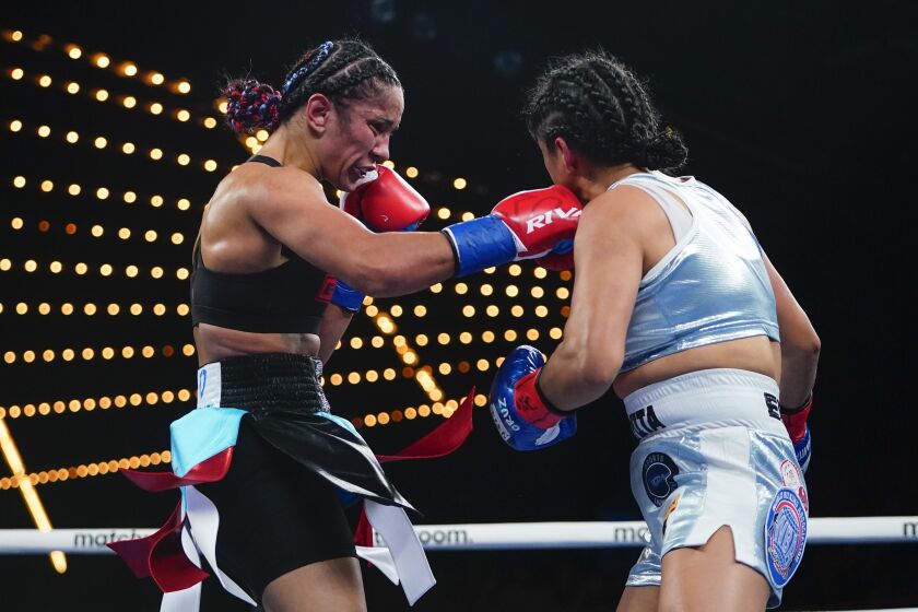 Puerto Rico's Amanda Serrano, left, punches Mexico's Erika Cruz Hernandez during the third round of a women's featherweight championship boxing bout Saturday, Feb. 4, 2023 in New York. Serrano won the fight. (AP Photo/Frank Franklin II)