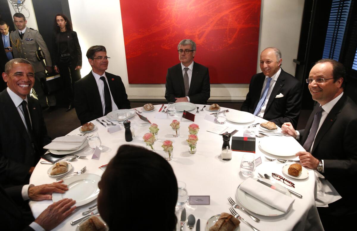 President Obama dines with French President Francois Hollande, far right, and French Foreign Minister Laurent Fabius, 2nd from right, at Le Chiberta restaurant in Paris.