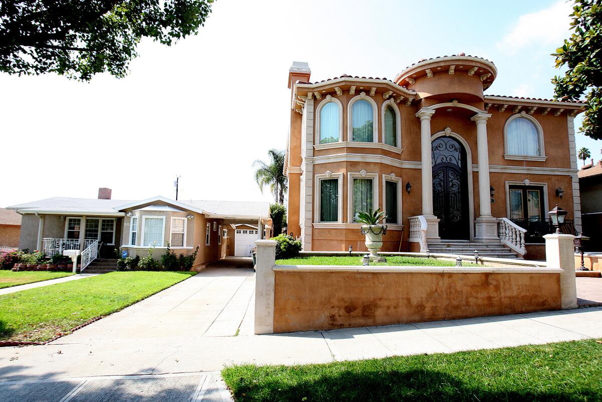 A home in Burbank that is considered "mansionized" dwarfs the residence on the left on Monday, August 26, 2013. Burbank historical officials will discuss guidelines in dealing with mansionization.