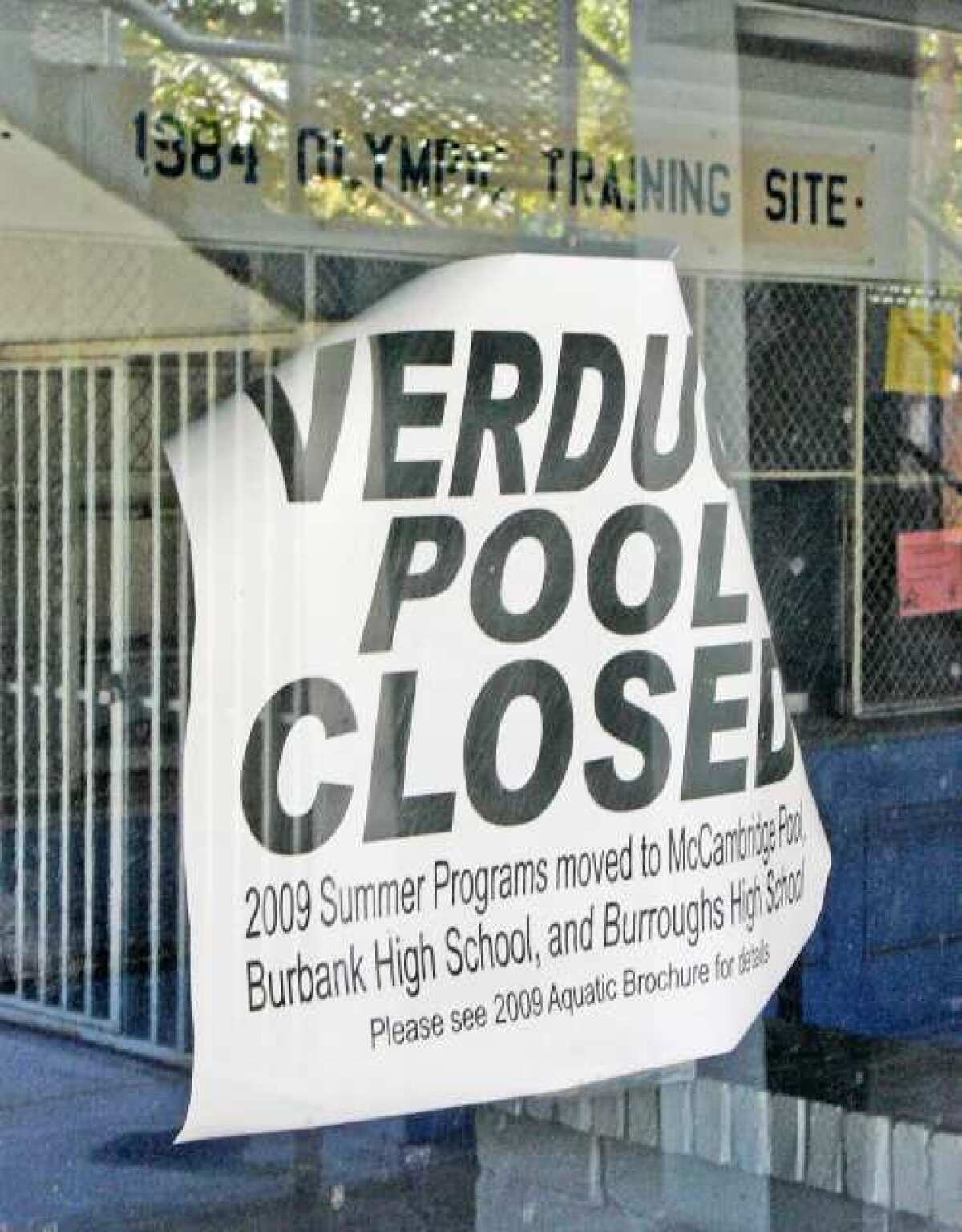A sign, that seems to have been on the door since 2009, with the 1984 Olympic Training Site sign inside. The pool has been closed since 2008.